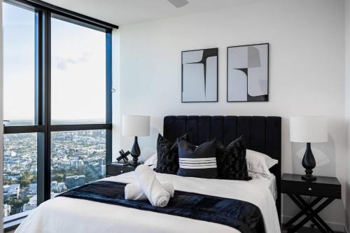 a bedroom with a large bed with a large window at 1Bedroom Apt in Queen's Wharf lv 62 - Skyline and City view in Brisbane
