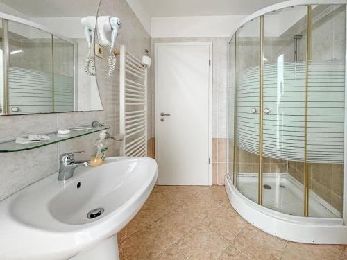 a bathroom with a sink and a shower at Hotel City Center in Braşov