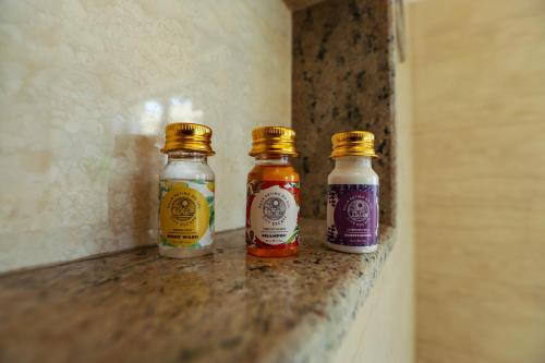two bottles of sauces sitting on top of a counter at Peaceful Escape in Gurgaon - Villa Retiro Do Sol in Manesar