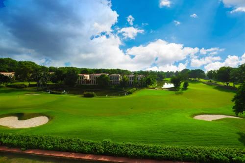 an overhead view of a golf course with a green at Peaceful Escape in Gurgaon - Villa Retiro Do Sol in Manesar