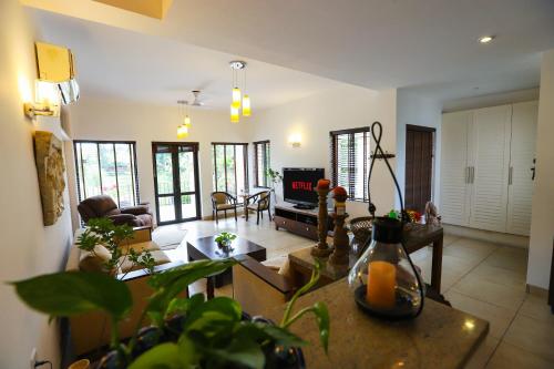a living room with a couch and a table at Peaceful Escape in Gurgaon - Villa Retiro Do Sol in Manesar