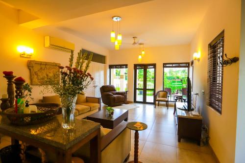 a living room with a couch and a table at Peaceful Escape in Gurgaon - Villa Retiro Do Sol in Manesar