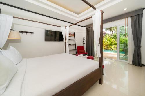 En eller flere senge i et værelse på Villa Prima - 3 Bedroom Private Pool Villa