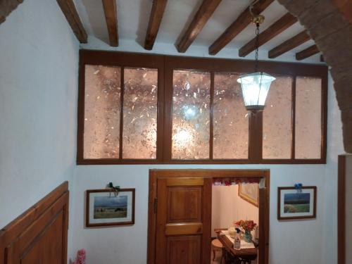 a room with a window and a door with a light at Casa Tarrini in Chianni