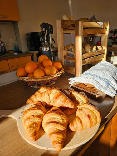 a table with a plate of croissants and oranges at Hotel Bohemia in Berlin