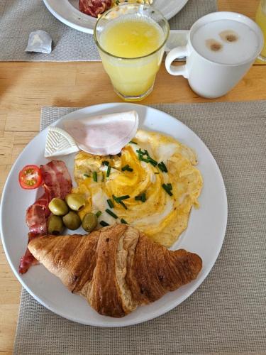 a white plate of food with a breakfast of omelet and eggs at Hotel Bohemia in Berlin