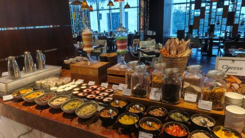 a buffet of different types of food on a table at Renaissance Dhaka Gulshan Hotel in Dhaka