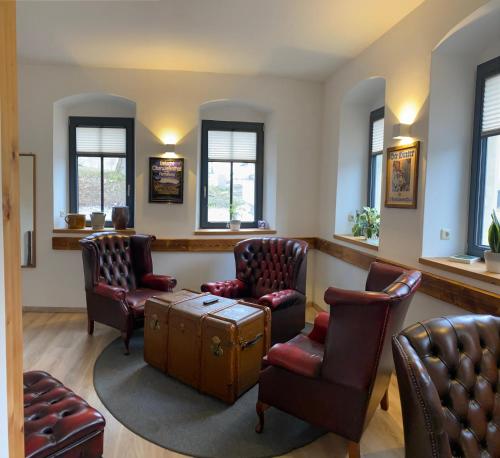 a waiting room with chairs and a table with a suitcase at Alpina Lodge Hotel Oberwiesenthal in Kurort Oberwiesenthal