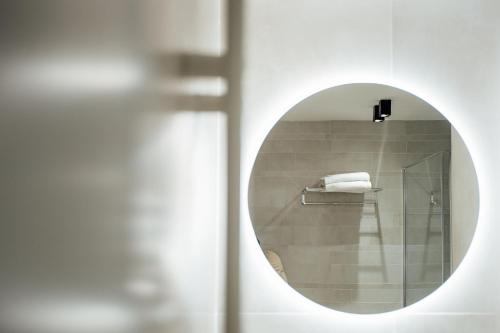 a mirror in a bathroom with a towel at Central Suites in Chieti