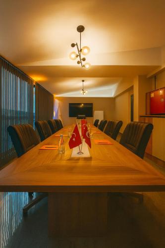 a conference room with a long wooden table and chairs at Rest By Dedeman Sapanca in Sapanca