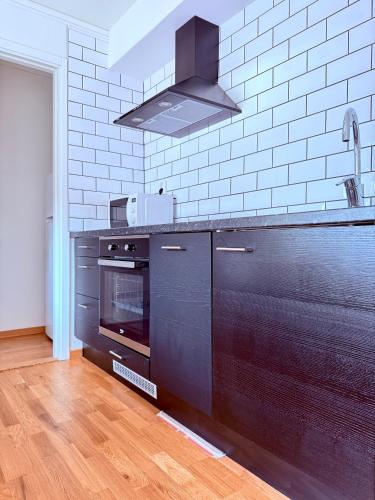 a kitchen with a black counter and a stove at Easy Livin' Apartment Hotel in Växjö