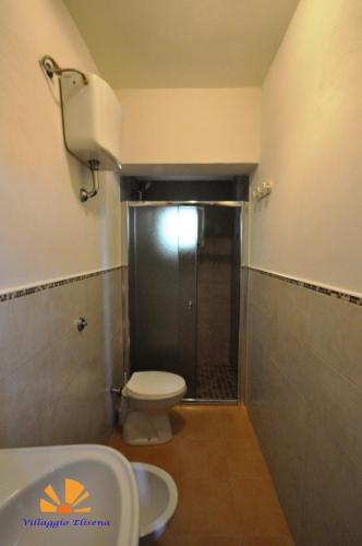 a small bathroom with a toilet and a shower at Villaggio Elisena in Vieste