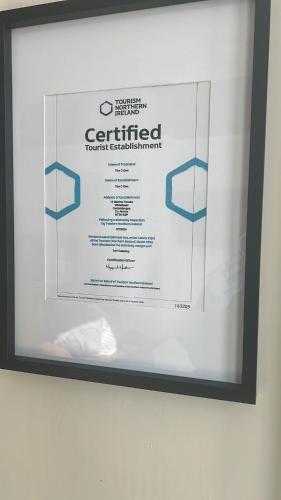 a framed sign hanging on a wall at The C Den Amazing Seaview, ground floor, free wifi & parking in Whitehead