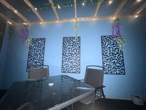 a dining room with a glass table and two chairs at The C Den Amazing Seaview, ground floor, free wifi & parking in Whitehead
