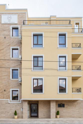 an apartment building with white windows at 5 Villa Vitosha Classic Stays in Hisarya