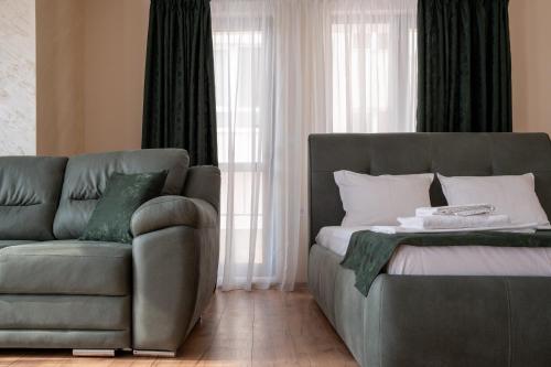 a living room with a couch and a couch and a chair at 5 Villa Vitosha Classic Stays in Hisarya