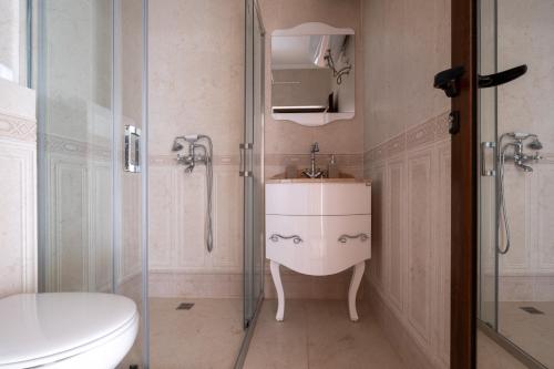 a bathroom with a sink and a shower at 5 Villa Vitosha Classic Stays in Hisarya
