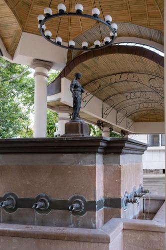 a statue under a building with a chandelier at 5 Villa Vitosha Classic Stays in Hisarya