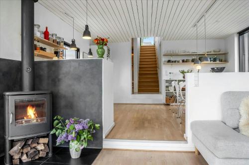 a living room with a fireplace and a couch at Summer House Close To Nature By The Limfjord in Nykøbing Mors