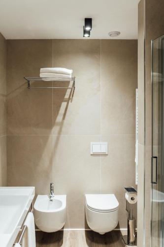 a bathroom with a toilet and a sink at Central Suites in Chieti