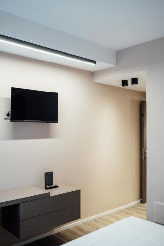 a living room with a tv on a wall at Central Suites in Chieti