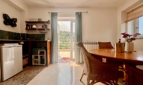 a kitchen with a wooden table and a refrigerator at NEW! Remote cosy apartment in Covas