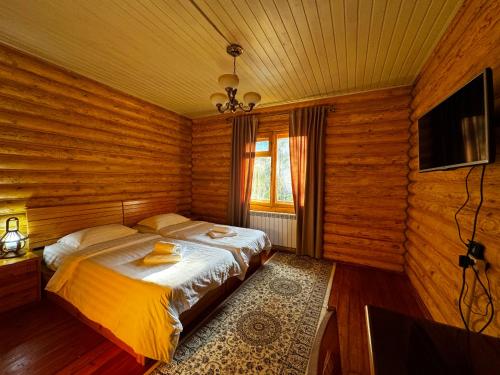 a bedroom with a bed in a wooden room at ProLes Burabay Eco Hotel in Borovoye