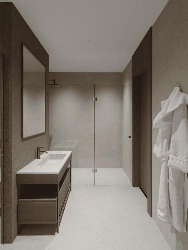 a bathroom with a sink and a shower and a mirror at Yevlakh City Hotel in Yevlax