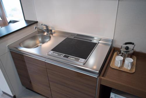 Kuchyň nebo kuchyňský kout v ubytování Hotel Trad