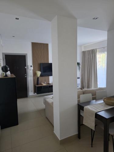 a living room with a couch and a table at Cavalo Preto Luxury Beach Resort - C201 in Quarteira