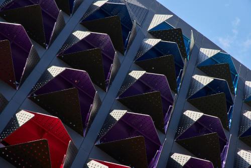 a wall of purple and black triangles at Calle Flora Hotel by Jalo in Medellín