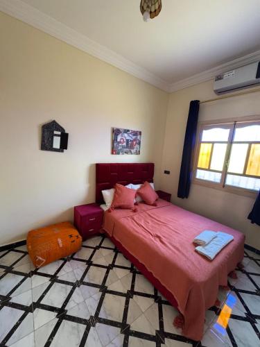 a bedroom with a large bed with a red blanket at Villa Privée avec Piscine et Calme Absolu 