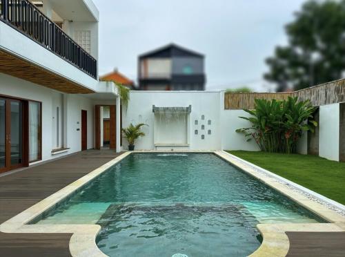 a swimming pool in the backyard of a house at Casa De Cuentos Bali in Denpasar