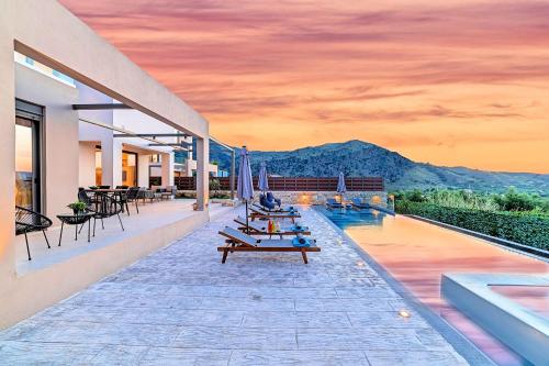 a house with a pool with tables and chairs at Minaos in Kournás