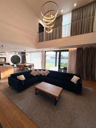 a living room with a black couch and a table at KarLa in Otopeni