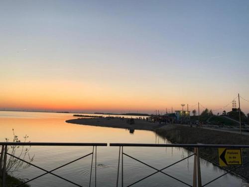 a view of a body of water at sunset at Holiday Home in Harderwijk near Veluwemeer in Harderwijk