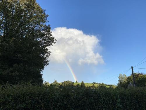 a rainbow in the sky with a cloud at Noahs Ark Shepherds Hut in Launceston