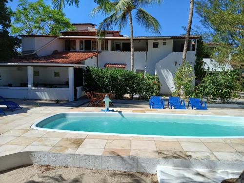 a swimming pool in front of a house at Pousada Unidos in Jijoca de Jericoacoara