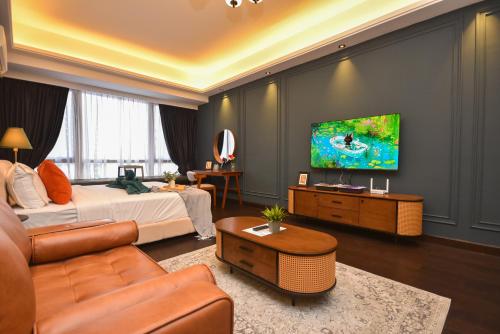a living room with a bed and a tv at R&F Princess Cove by Nest Home at Johor Bahru in Johor Bahru