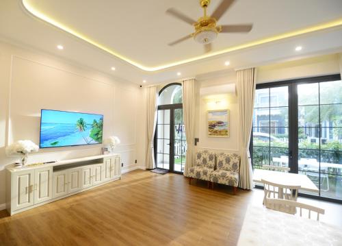 a large living room with a flat screen tv at Liséa Wonderland Novaworld Hồ Tràm - Spacious and Cosy Entire Villa by the beach in Xuyên Mộc