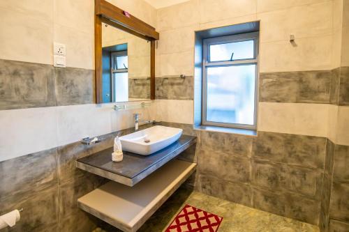 a bathroom with a sink and a window at Grand Argyle Resort in Hatton