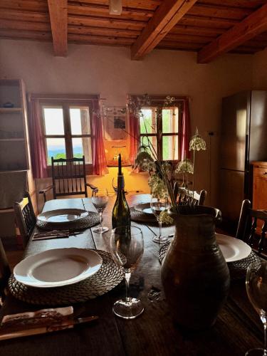 a dining room table with plates and wine glasses at Copacis Country Home in Breb