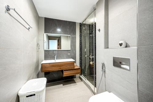a bathroom with a sink and a shower at Room in an 4BR High Rise with Burj Khalifa and Fountain Views in Dubai
