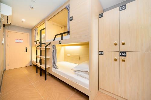 a room with bunk beds and a hallway at Dengba Inn Wuning Subway Station Branch in Shanghai