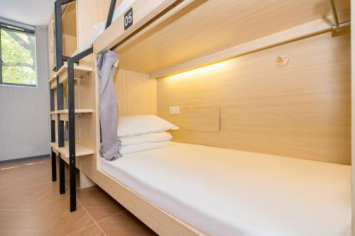 a small room with two bunk beds in it at Dengba Inn Wuning Subway Station Branch in Shanghai