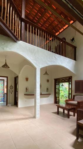 a living room with a couch and a table at Anjali in Ilha de Boipeba