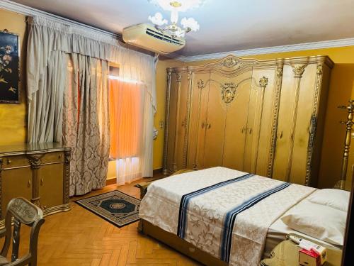 a bedroom with a bed and a chandelier at Cairo 1890 in Cairo