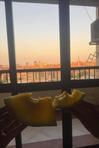 a yellow pillow sitting on a table in front of a window at Cairo 1890 in Cairo