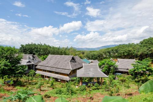 an aerial view of a house in a forest at Dai House in Xishuangbanna Village in Menghan