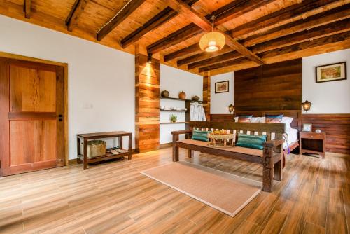 a bedroom with a bed and a wooden ceiling at Dai House in Xishuangbanna Village in Menghan